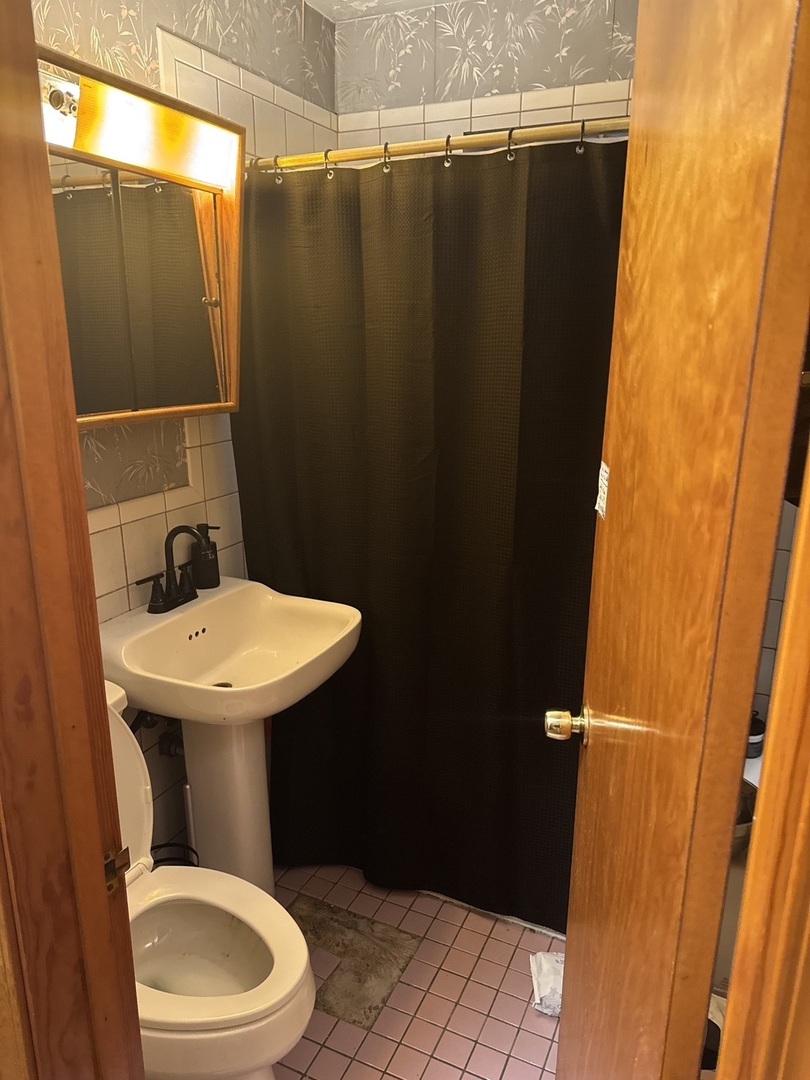 3314 South 58th Avenue Cicero, IL 60804 - Photo 10 of 13 a bathroom with a sink toilet and shower