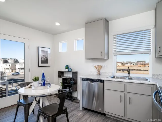 a kitchen with a sink cabinets and wooden floor