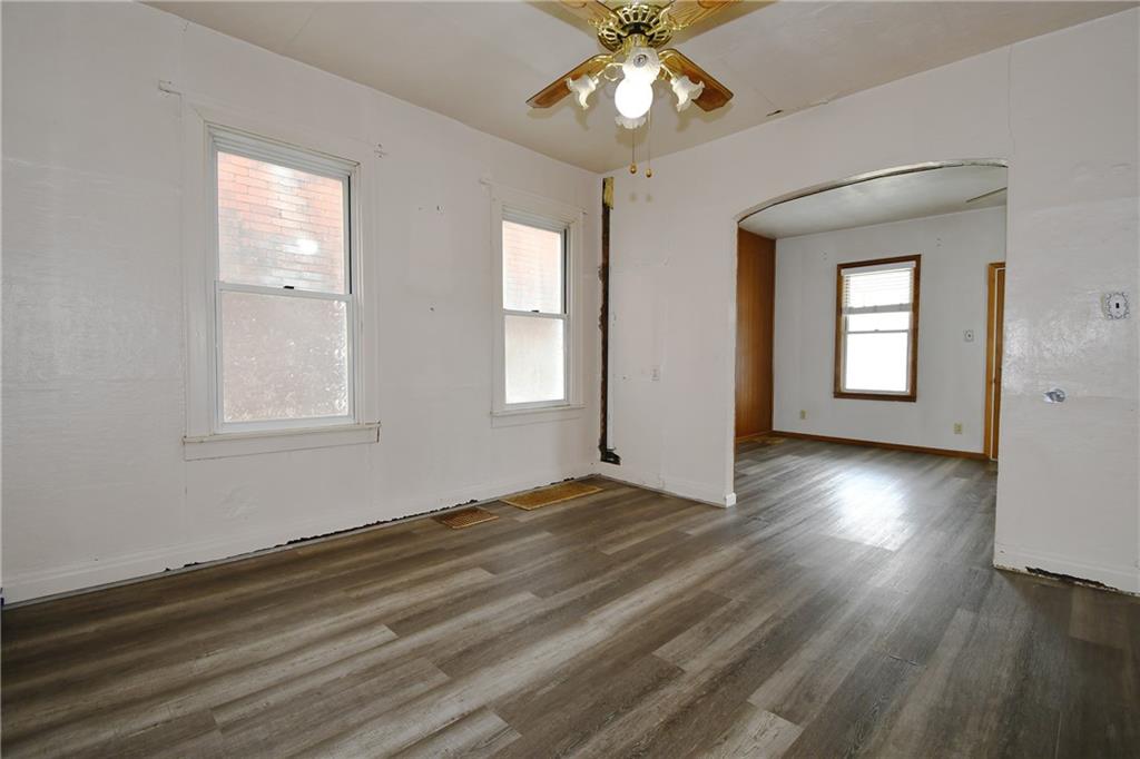 126 Rinne Street Pittsburgh, PA 15210 - Photo 11 of 24 a view of an empty room with wooden floor and a window