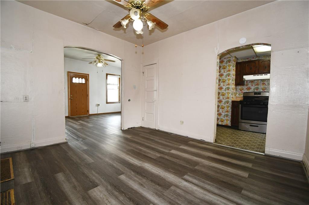 126 Rinne Street Pittsburgh, PA 15210 - Photo 12 of 24 wooden floor in an empty room with a window