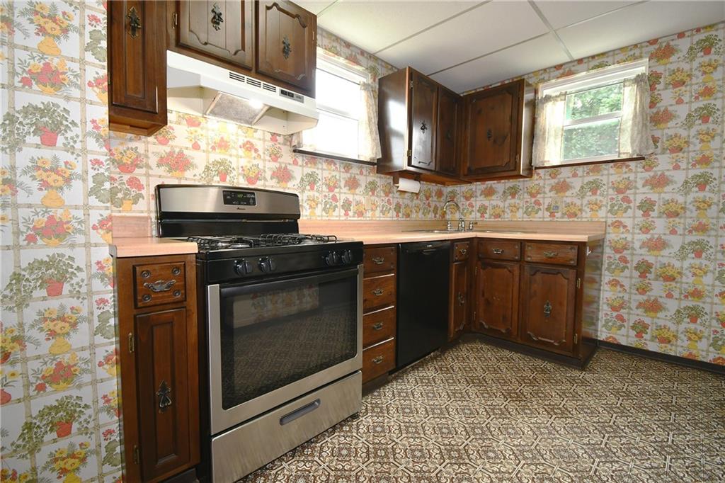126 Rinne Street Pittsburgh, PA 15210 - Photo 13 of 24 a kitchen with stainless steel appliances a stove a sink and a microwave