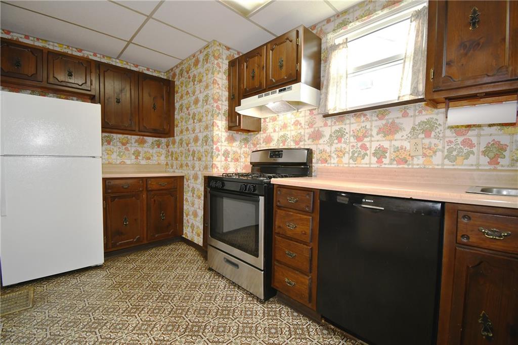 126 Rinne Street Pittsburgh, PA 15210 - Photo 14 of 24 a kitchen with stainless steel appliances granite countertop a sink stove and refrigerator