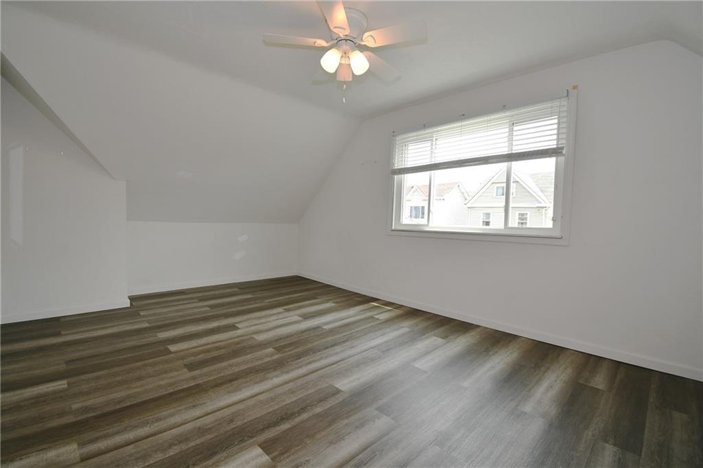 126 Rinne Street Pittsburgh, PA 15210 - Photo 15 of 24 wooden floor in an empty room with a window
