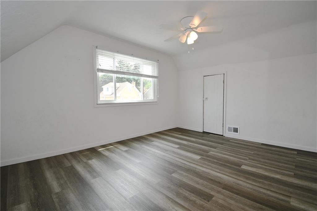 126 Rinne Street Pittsburgh, PA 15210 - Photo 16 of 24 wooden floor in an empty room with a window