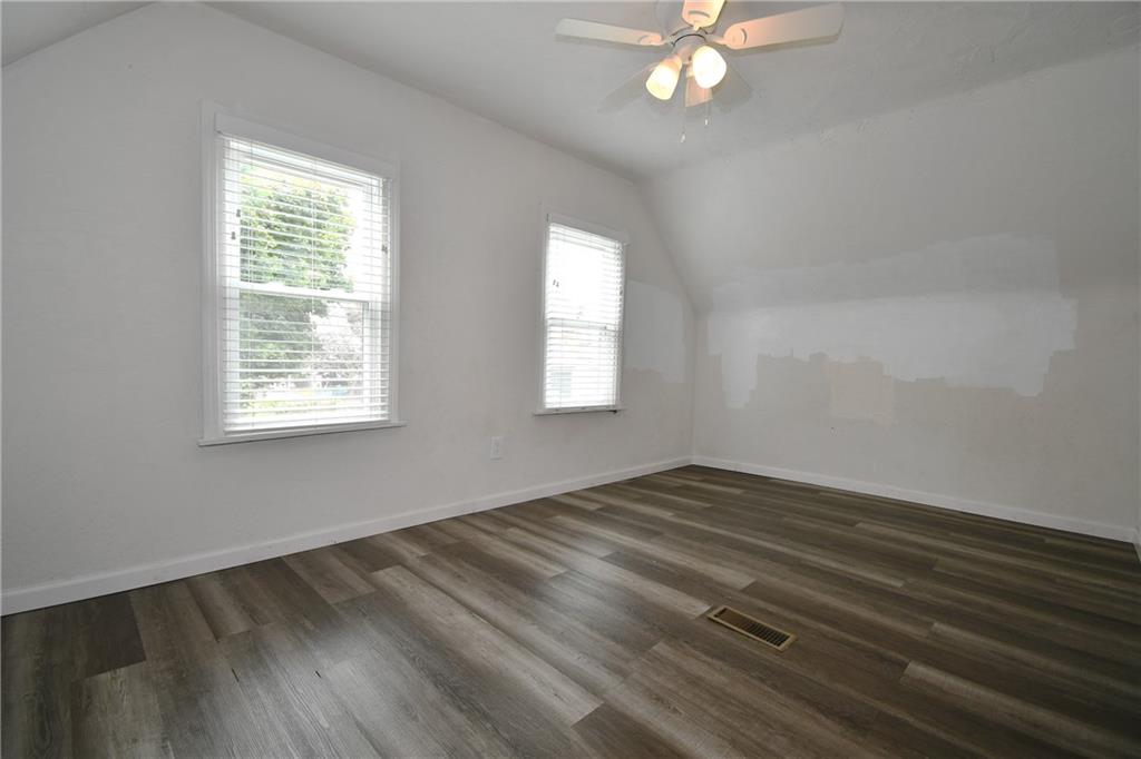 126 Rinne Street Pittsburgh, PA 15210 - Photo 19 of 24 wooden floor in an empty room with a window