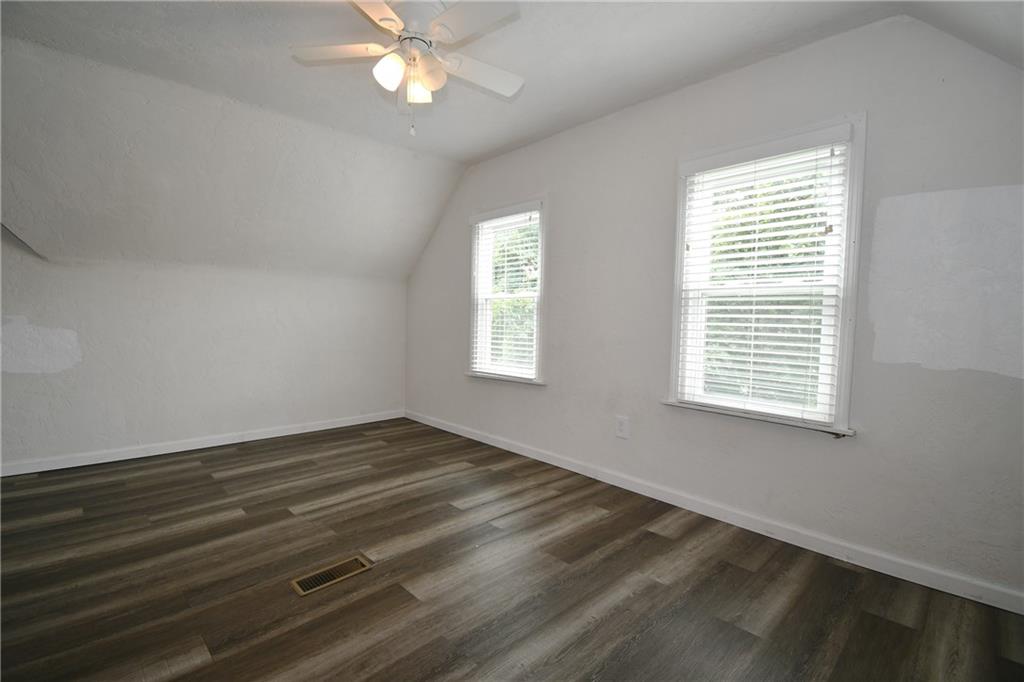 126 Rinne Street Pittsburgh, PA 15210 - Photo 20 of 24 a view of an empty room with wooden floor and a window