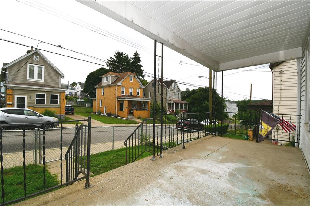 126 Rinne Street Pittsburgh, PA 15210 - Photo 3 of 24 a view of a houses with a small yard and furniture