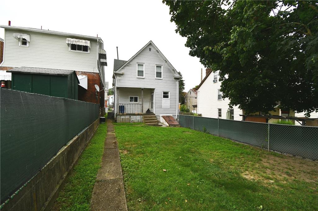 126 Rinne Street Pittsburgh, PA 15210 - Photo 4 of 24 a view of an house with backyard space and a tree