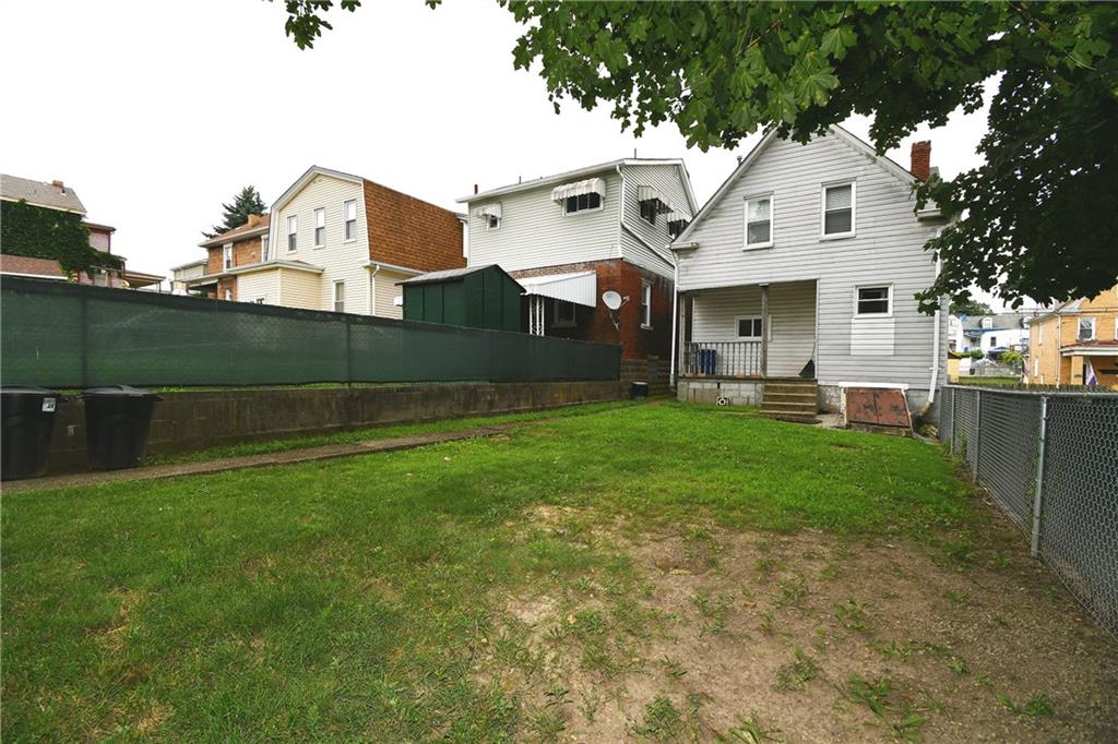 126 Rinne Street Pittsburgh, PA 15210 - Photo 5 of 24 a front view of a house with a yard