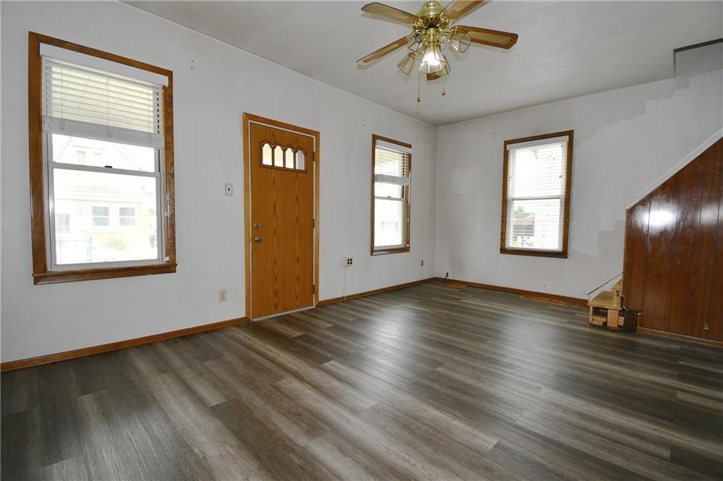 126 Rinne Street Pittsburgh, PA 15210 - Photo 6 of 24 a view of an empty room with a window and wooden floor
