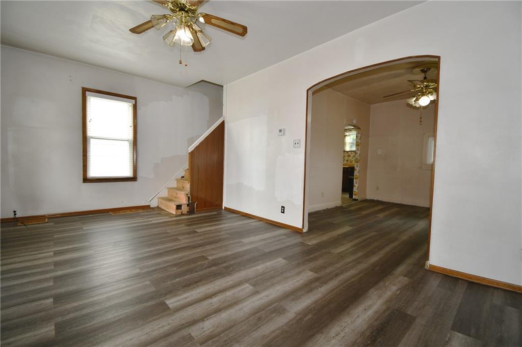 126 Rinne Street Pittsburgh, PA 15210 - Photo 7 of 24 a view of a livingroom with wooden floor and a ceiling fan