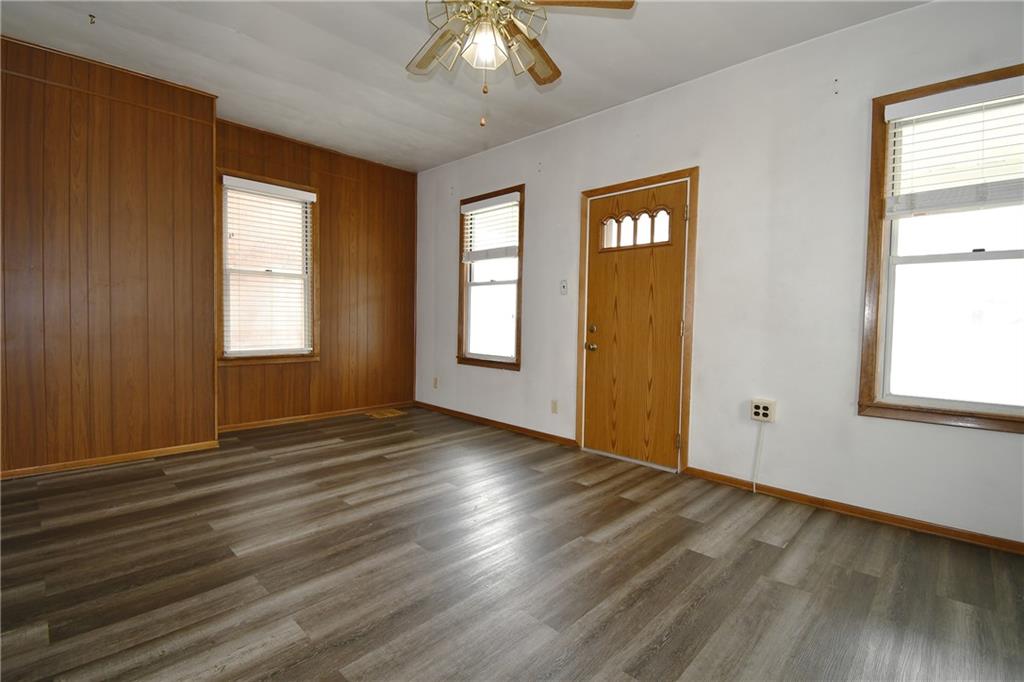 126 Rinne Street Pittsburgh, PA 15210 - Photo 8 of 24 a view of an empty room with window and wooden floor