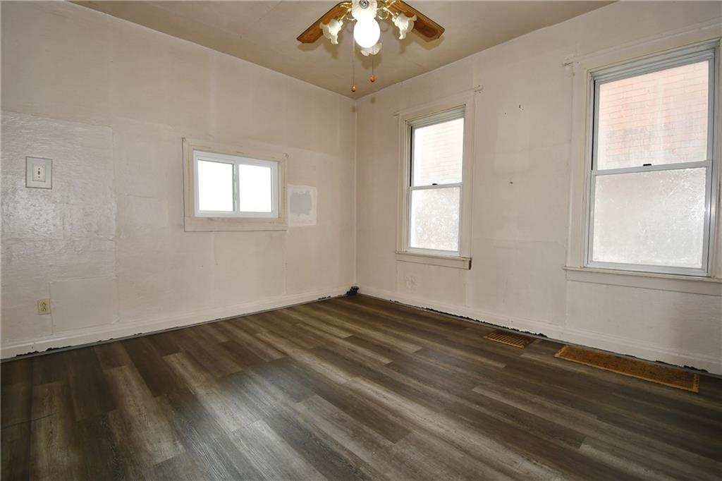 126 Rinne Street Pittsburgh, PA 15210 - Photo 10 of 24 a view of an empty room with wooden floor and a window