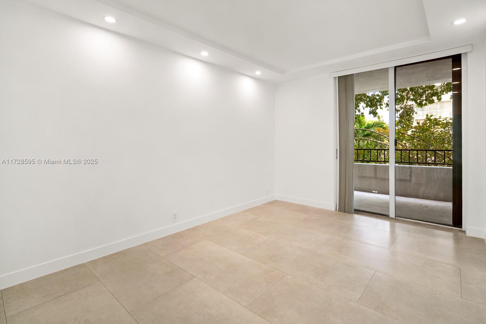 141 Crandon Boulevard, Unit 229 Key Biscayne, FL 33149 - Photo 16 of 30 an empty room with sliding glass door and shower