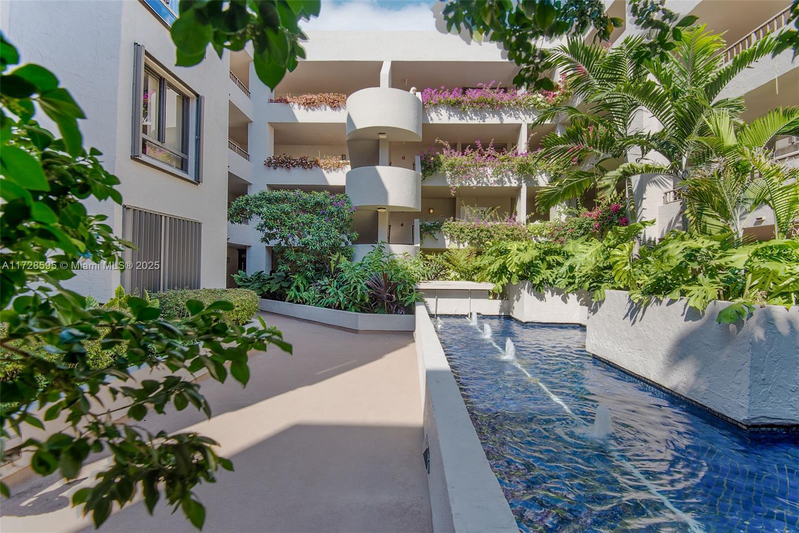 141 Crandon Boulevard, Unit 229 Key Biscayne, FL 33149 - Photo 20 of 30 a view of a multi story building with a yard