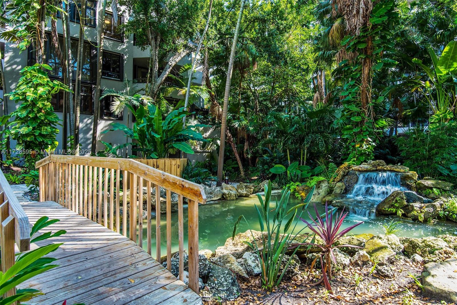 141 Crandon Boulevard, Unit 229 Key Biscayne, FL 33149 - Photo 24 of 30 a balcony with potted plants and large trees