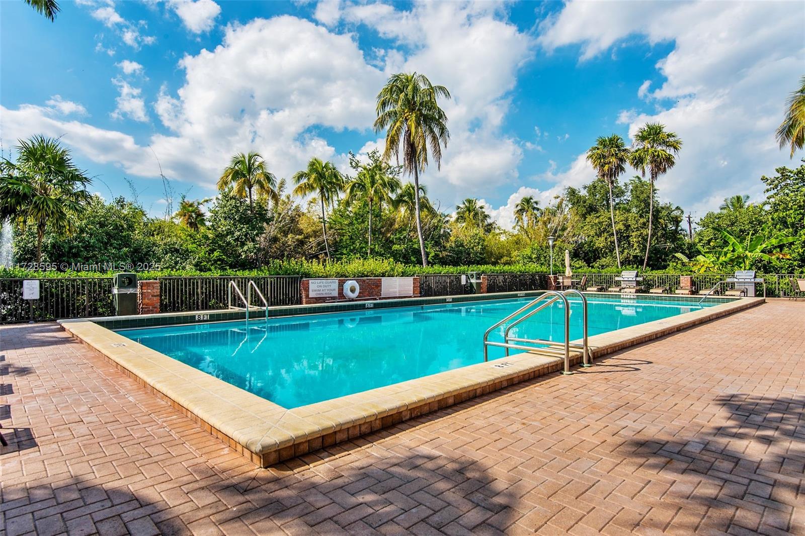 141 Crandon Boulevard, Unit 229 Key Biscayne, FL 33149 - Photo 25 of 30 a view of a swimming pool with a yard