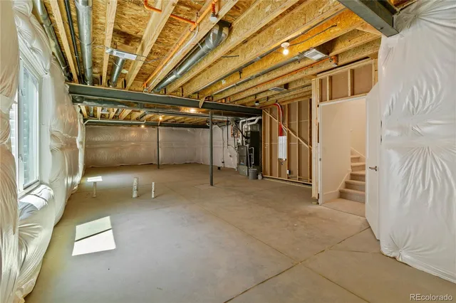 a backyard of a house with barbeque oven and parked next to a road