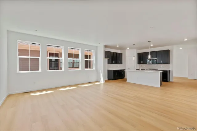 a kitchen with a sink a counter space and a chandelier