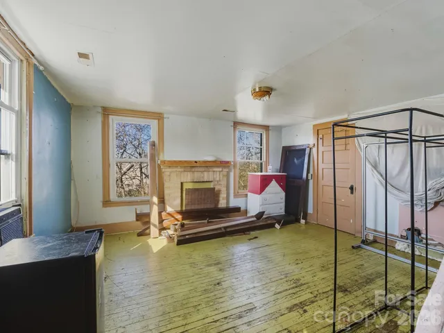 a bathroom with a granite countertop sink mirror vanity and toilet
