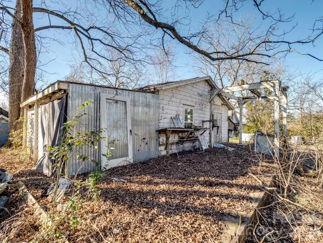 a view of a house with a yard and a tree