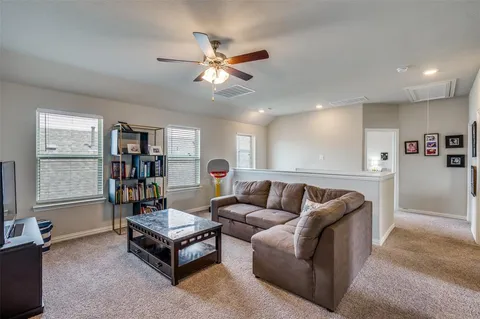 a living room with furniture and a bookshelf