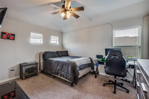 a bedroom with a bed chair and a window