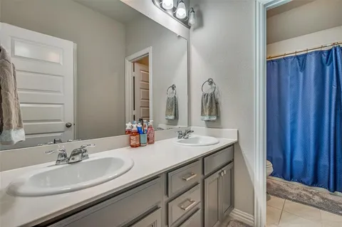 a bathroom with a double vanity sink and a mirror