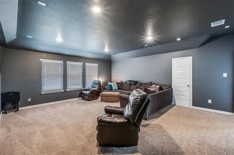 a room with furniture gym equipment and a large window