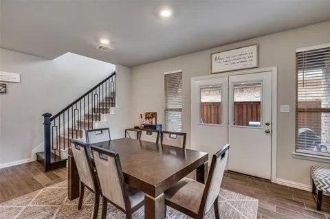 a dining room with furniture window and wooden floor