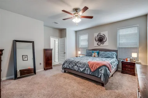 a bedroom with a bed and a large mirror