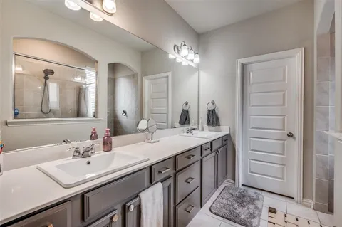a bathroom with a sink vanity and a mirror