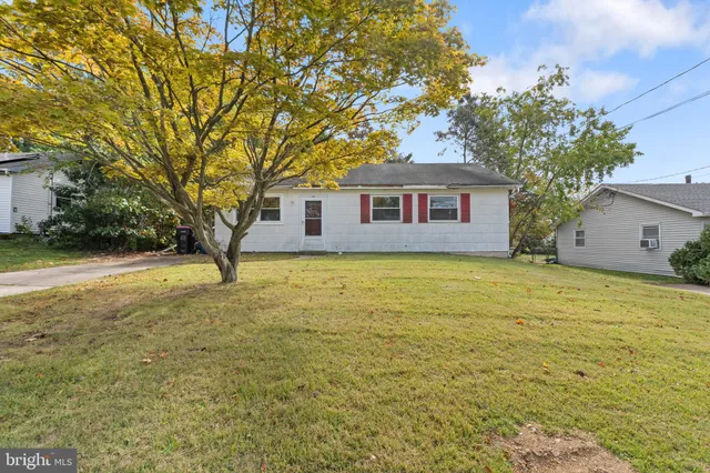 a house view with swimming pool in front of it