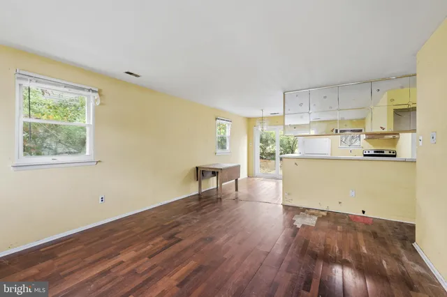a room with wooden floor and window