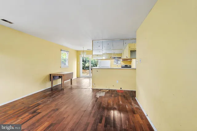 a room with a wooden floor and a window