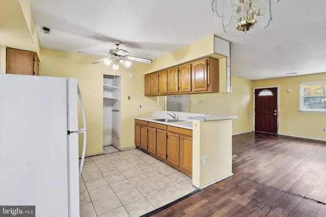 a kitchen with a refrigerator a stove top oven a sink and dishwasher