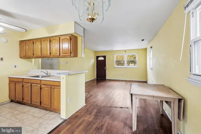 a view of a kitchen with wooden floor and electronic appliances