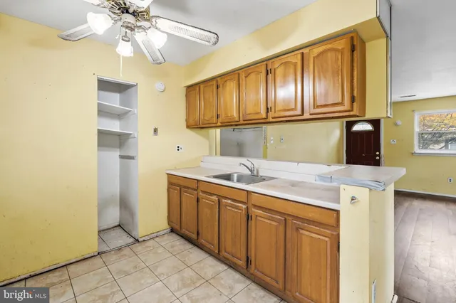 a kitchen with cabinets a sink and appliances