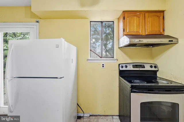 a white refrigerator freezer sitting inside of a kitchen