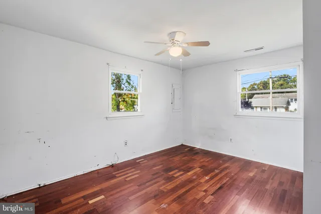 a view of empty room with wooden floor