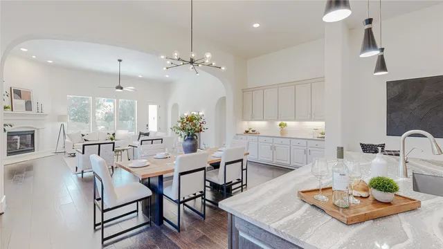 a view of a dining room and livingroom with furniture window and wooden floor