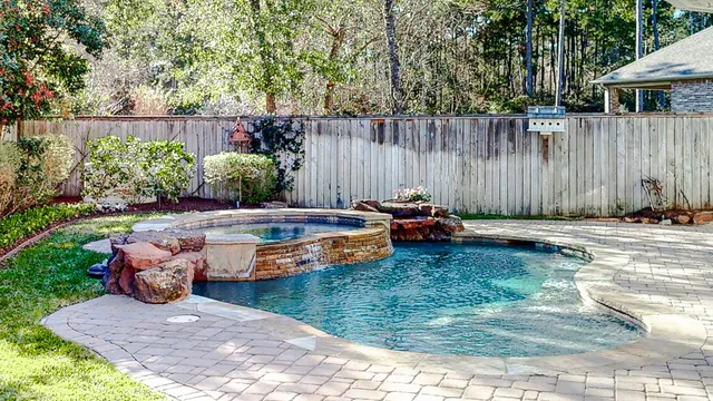 a front view of yellow house with flower pots