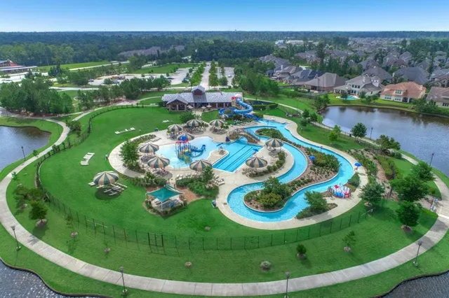 a view of a swimming pool and trees in the background