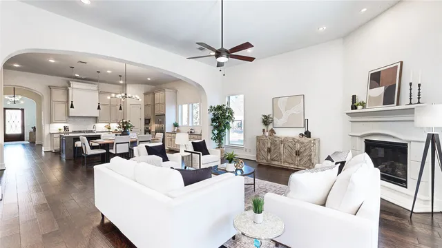 a living room with furniture fireplace and kitchen view
