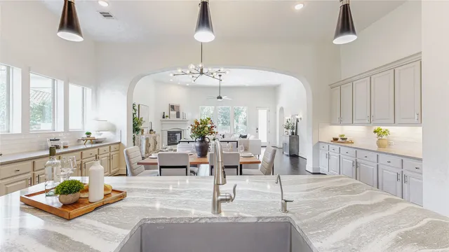 a kitchen with kitchen island a large counter top space a sink stainless steel appliances and cabinets