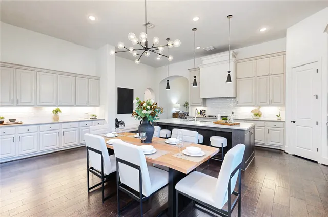 a living room with furniture chandelier and a view of kitchen