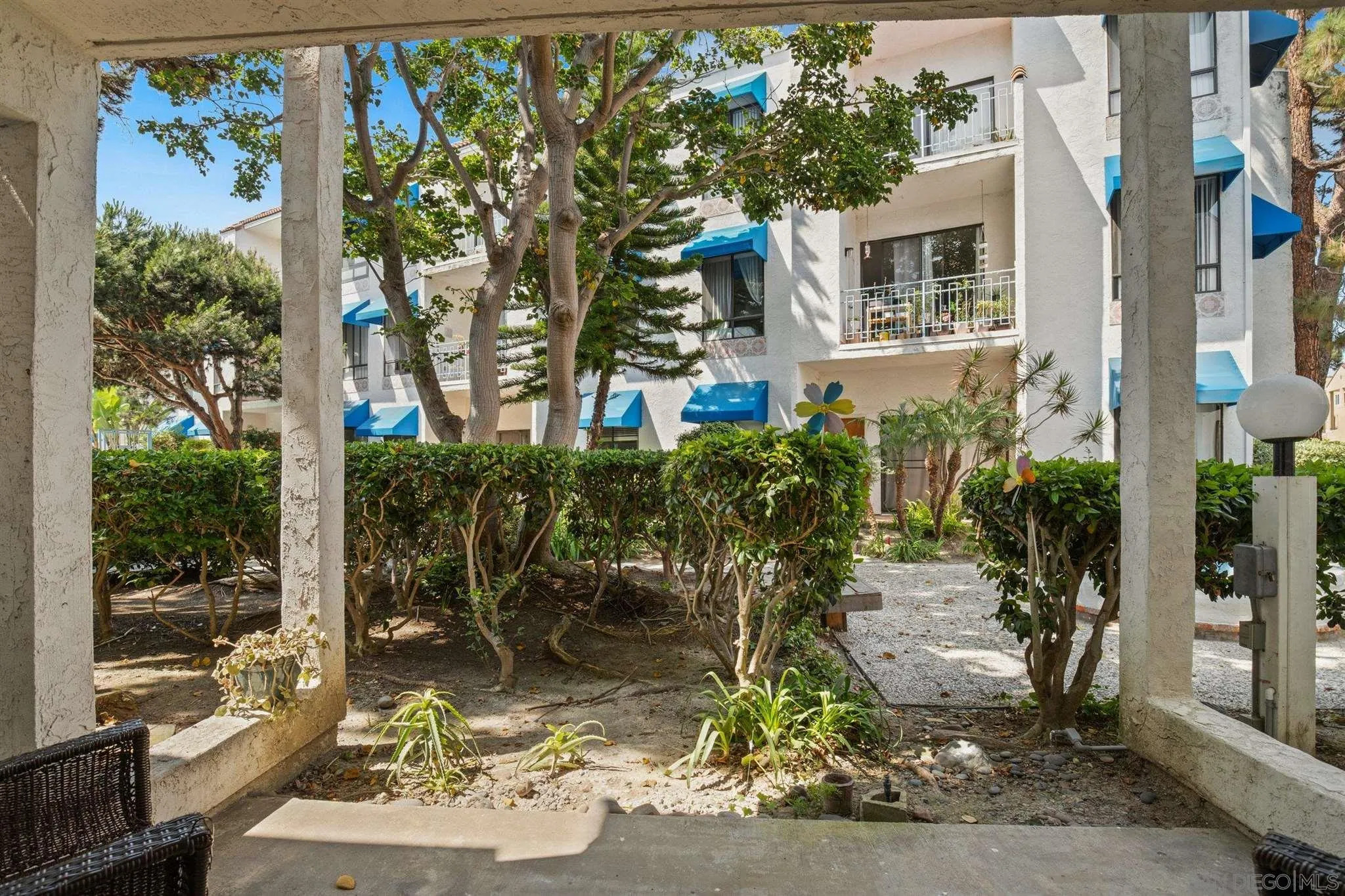 a view of a patio with table and chairs and potted plants