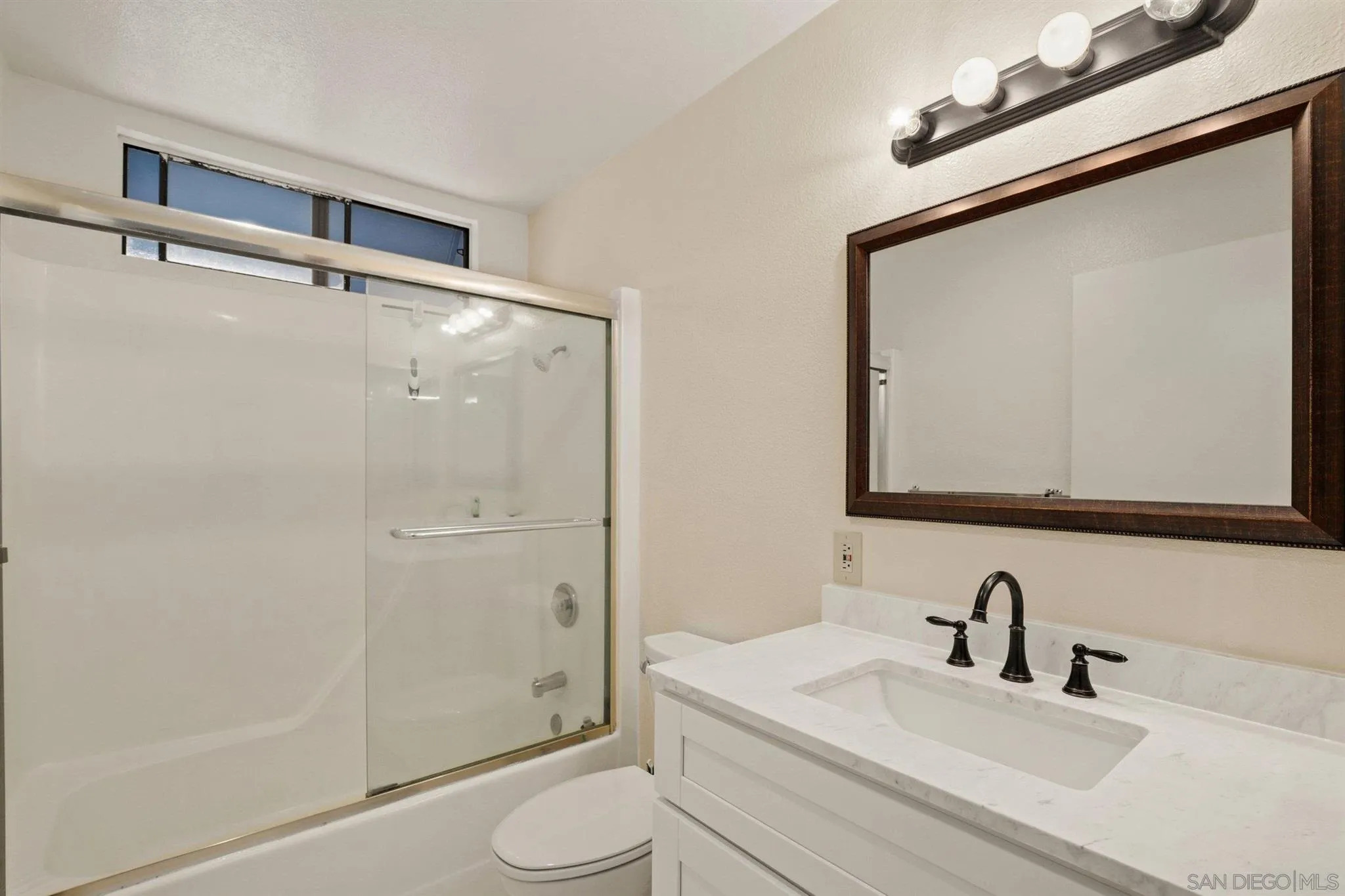 8308 Regents Road, Unit 1H San Diego, CA 92122 - Photo 11 of 14 a bathroom with a sink a toilet and shower