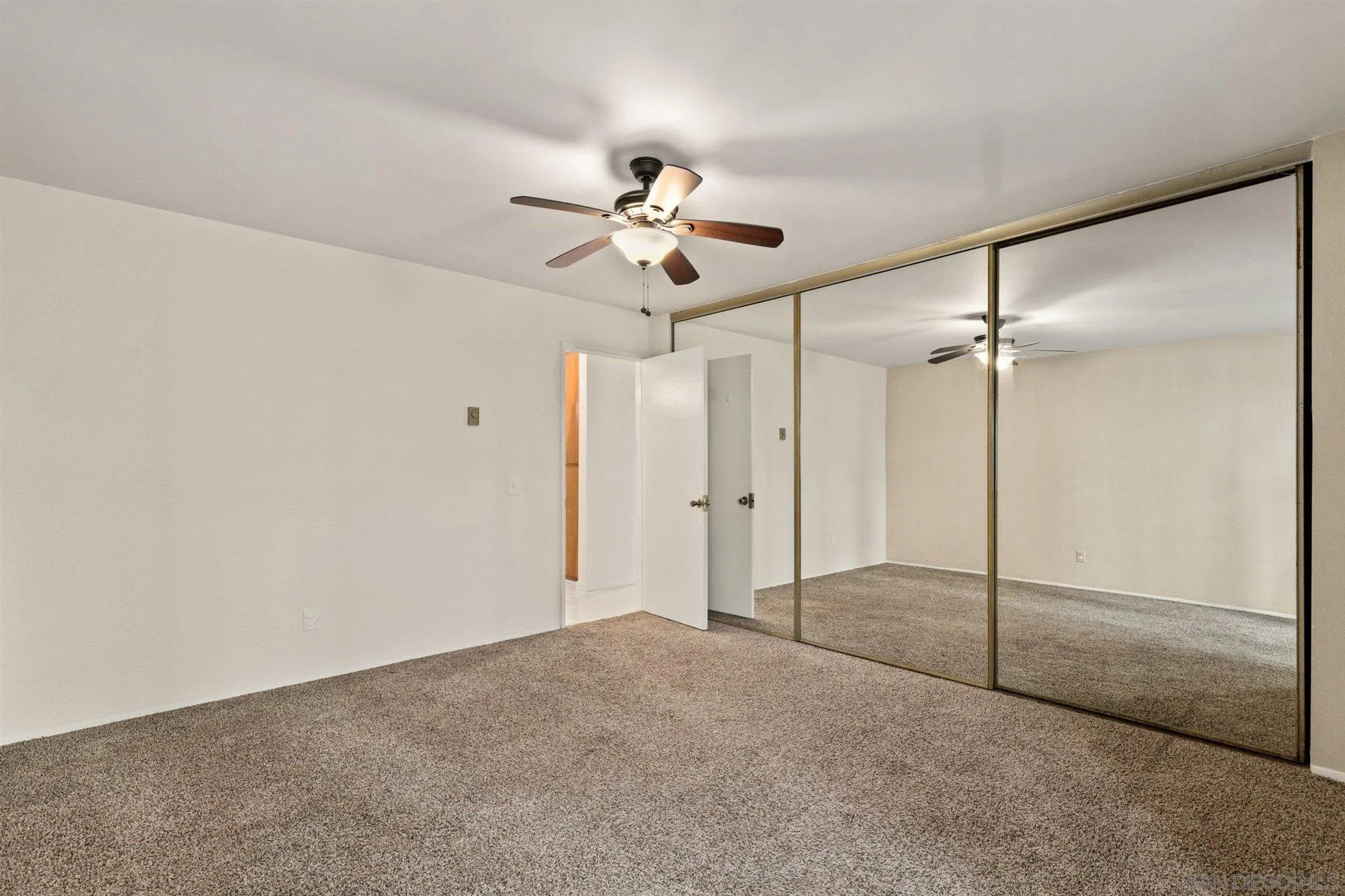 8308 Regents Road, Unit 1H San Diego, CA 92122 - Photo 13 of 14 a view of empty room with a ceiling fan