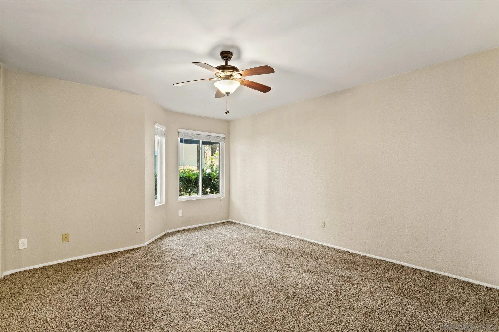8308 Regents Road, Unit 1H San Diego, CA 92122 - Photo 14 of 14 a view of room with ceiling fan and window